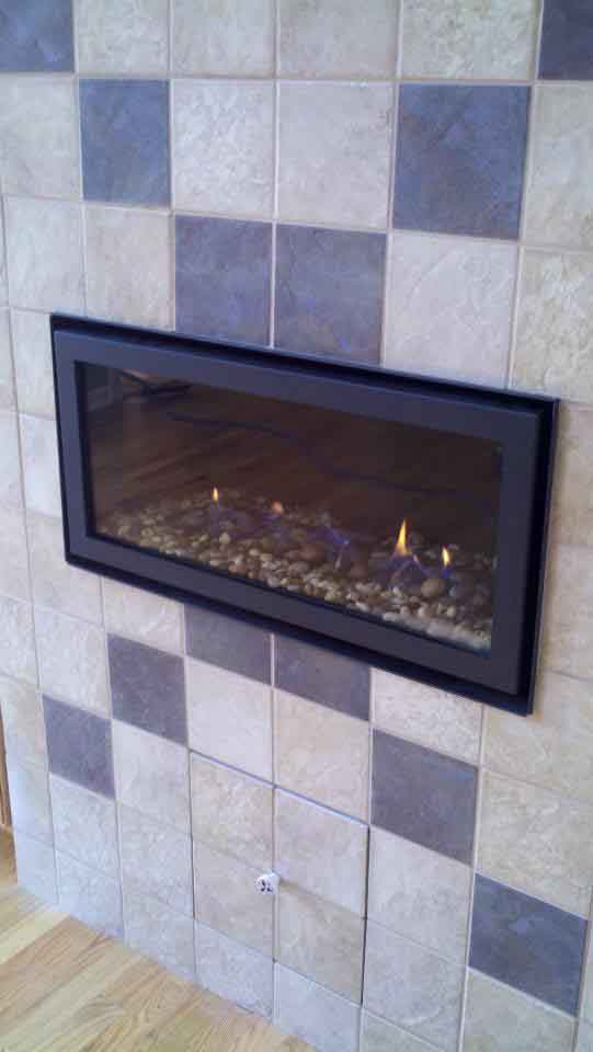 Completed fireplace facelift with new modern insert set with custom blue and white tile