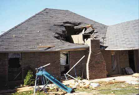 House with caved in roof and damaged chimney