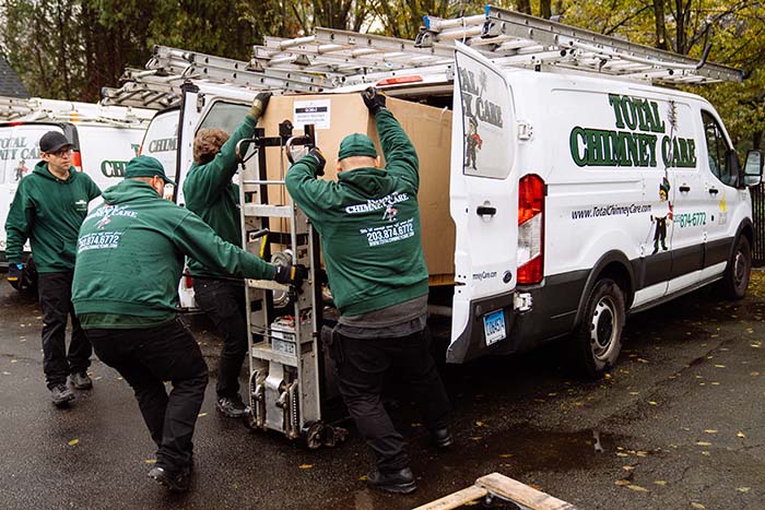 Total Chimney Care- Image of Technicians Technicians emptying van
